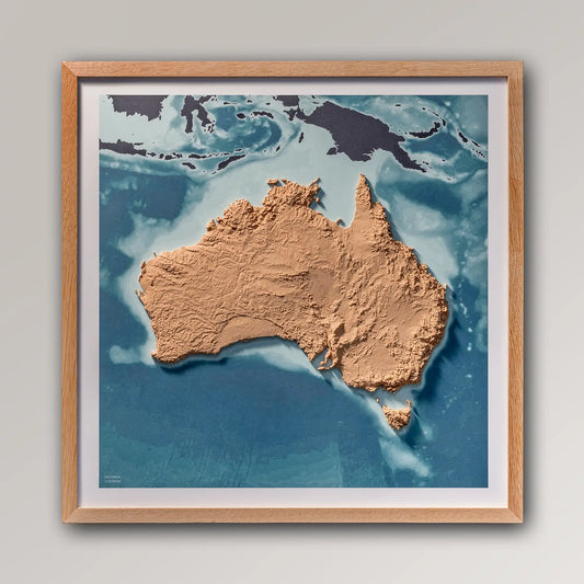 Framed 3D topographic map of Australia, 40x40cm art board inside an oak frame on a light grey wall – TerraFrames