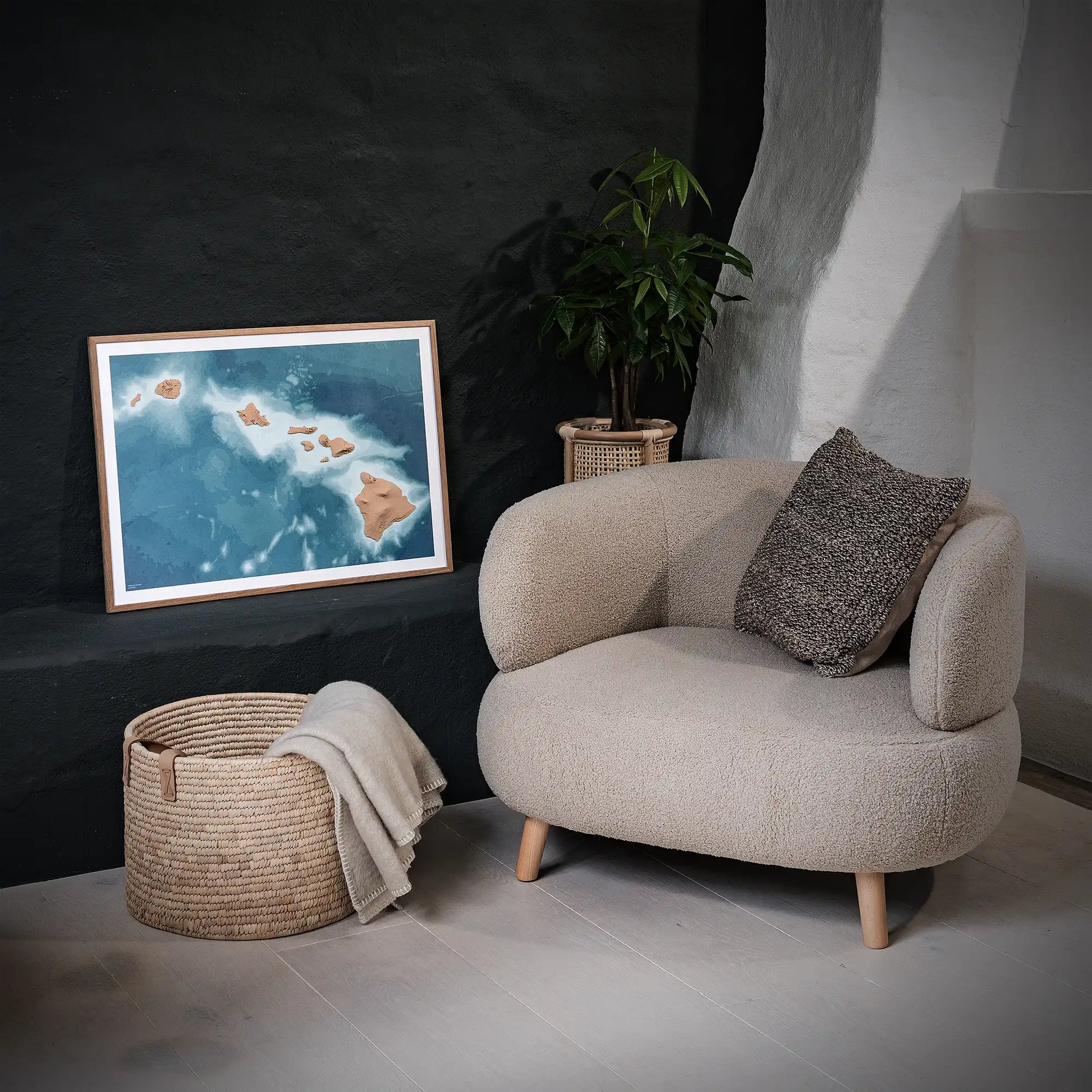 Framed 3D topographic map of Hawaii, in a minimalist room with a beige armchair and a black wall – TerraFrames