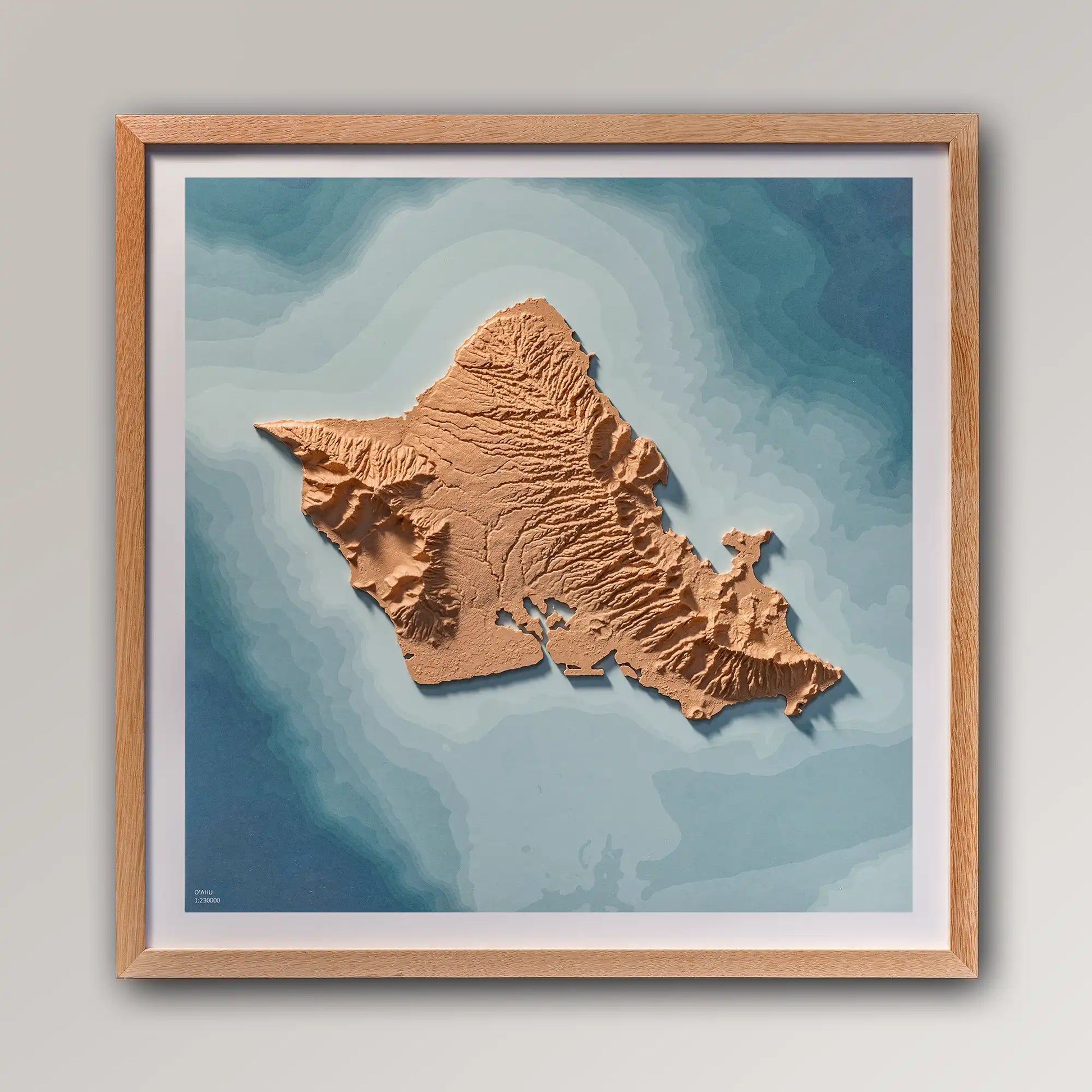 Framed 3D topographic map of O'ahu (Oahu), 40x40cm art board inside an oak frame on a light grey wall – TerraFrames