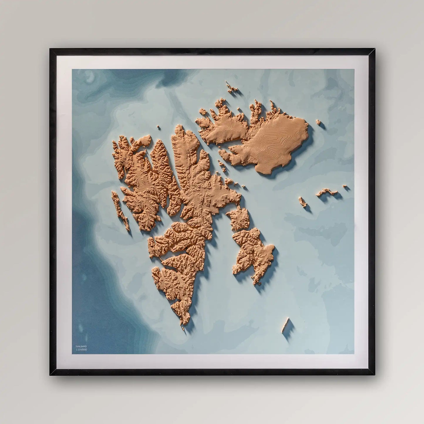 Framed 3D topographic map of Svalbard, 40x40cm art board inside a black frame on a light grey wall – TerraFrames