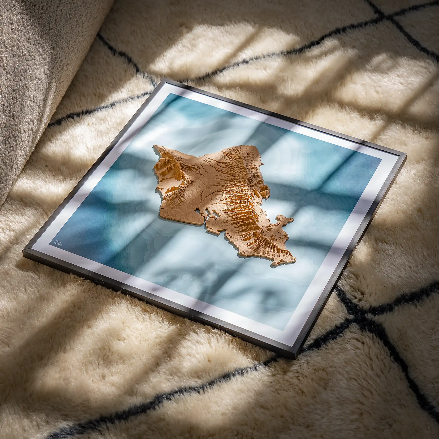 3D closeup of a topographic map of O'ahu (Oahu) on white wool carpet, natural sunlight through a window – TerraFrames