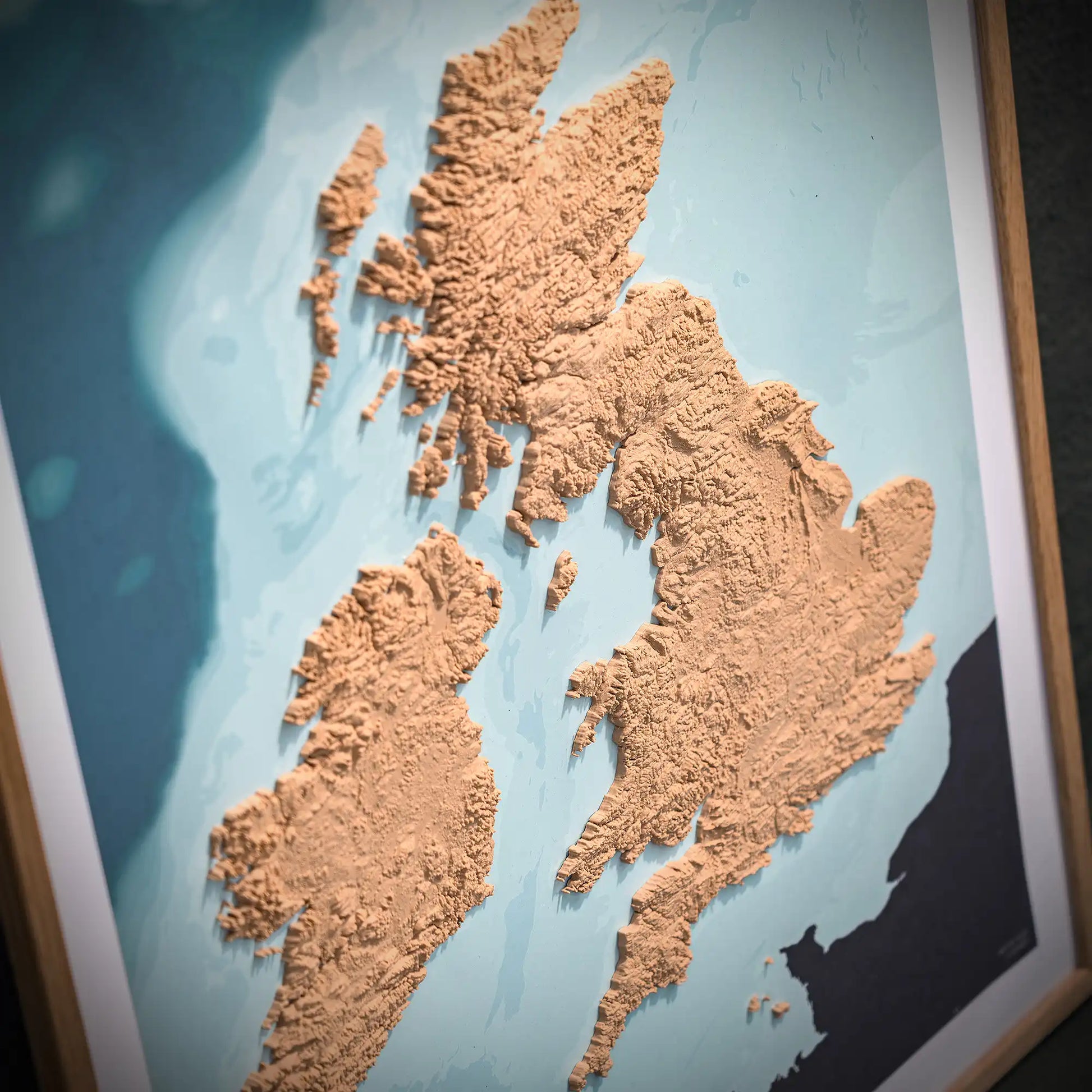3D closeup of a topographic map of England, Scotland and Ireland on a light blue background – TerraFrames